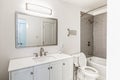 Freshly renovated bathroom with shower, toilet, mirror, faucet and sink