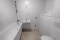 Freshly renovated bathroom with toilet, shower, sink