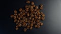 Freshly roasted coffee beans on dark background