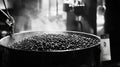 Freshly roasted coffee beans emitting steam in roastery Royalty Free Stock Photo