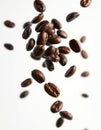 Freshly roasted coffee beans falling in a visually appealing manner against a light background Royalty Free Stock Photo
