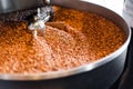 Freshly roasted coffee beans from a large roaster in the cooling cylinder. Motion blur on the beans, selective focus Royalty Free Stock Photo