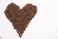 Freshly roasted coffee beans in shape of a heart isolated on white background. top view Royalty Free Stock Photo