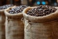 Freshly roasted coffee beans spilling from burlap sacks, ready for grinding and brewing Royalty Free Stock Photo