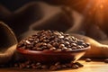 Freshly roasted coffee beans in wooden bowl in the morning, background with beautiful light and copy space, close up shot. Royalty Free Stock Photo