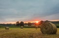 Freshly rolled bales of hay rest on a field at sunrise in Sussex County, NJ, late summer Royalty Free Stock Photo