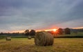 Freshly rolled bales of hay rest on a field at sunrise in Sussex County, NJ, late summer Royalty Free Stock Photo