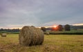 Freshly rolled bales of hay rest on a field at sunrise in Sussex County, NJ, late summer Royalty Free Stock Photo