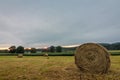 Freshly rolled bales of hay rest on a field at sunrise in Sussex County, NJ, late summer Royalty Free Stock Photo