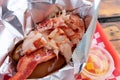 Freshly served delectable and iconic New England style lobster roll with butter