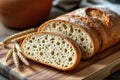 Freshly Sliced Artisanal Sourdough Bread with Raw Wheat on Rustic Wooden Board