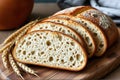 Freshly Sliced Artisanal Sourdough Bread with Raw Wheat on Rustic Wooden Board
