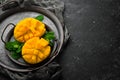 Freshly sliced mango on a metal plate. Tropical fruits. On a black stone background Royalty Free Stock Photo