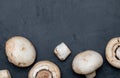 Freshly sliced mushrooms mushrooms, cut foot, Bisporus agaricus raw uncooked. Black slate background. Royalty Free Stock Photo