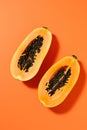 Freshly Sliced Papaya on Vibrant Orange Background AI Generated