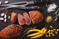 Freshly sliced roast duck breast closeup on a slate. horizontal