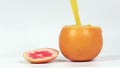 Freshly squeezed juice is poured into a grapefruit