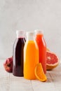 Freshly squeezed orange, grapefruit, pomegranate juices in transparent bottles. Healthy nutrition Royalty Free Stock Photo