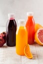 Freshly squeezed orange, grapefruit, pomegranate juices in transparent bottles. Healthy nutrition Royalty Free Stock Photo