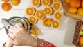 Freshly squeezed orange juice. Caucasian woman squeezing oranges using electric juicer. Royalty Free Stock Photo
