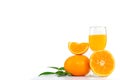 Freshly squeezed orange juice in a glass decorated with citrus fruits and orange leaves on white background Royalty Free Stock Photo