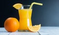 Freshly squeezed orange juice in glass with orange fruits on wooden background Royalty Free Stock Photo