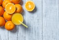 Freshly squeezed orange juice in glass with orange fruits on wooden background Royalty Free Stock Photo