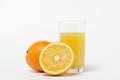 Freshly squeezed orange juice on a white background. A glass of orange juice and a cut orange next to it. Royalty Free Stock Photo