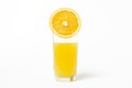 Freshly squeezed orange juice on a white background. A glass of orange juice and a cut orange next to it. Royalty Free Stock Photo