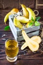 Freshly squeezed pear juice and ripe pear on a wooden table. The concept of nutrition for superfoods and health or detoxification