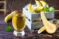 Freshly squeezed pear juice and ripe pear on a wooden table. The concept of nutrition for superfoods and health or detoxification