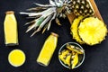 Freshly squeezed pineapple juice near fruit slices on black background top view Royalty Free Stock Photo