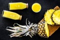 Freshly squeezed pineapple juice near fruit slices on black background top view Royalty Free Stock Photo