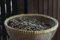 Freshly steamed peanuts sitting in a woven basket with steam rising off of them