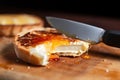 freshly toasted english muffin being buttered with a knife Royalty Free Stock Photo