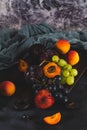 Freshly washed fruits with water droplets. bright high key look conveys freshness. Variety of fresh grapes, apricot and plumes on