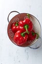 Freshly washed red peppers in a colander