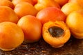 Freshly washed, ripe half sliced and whole apricots on a black cutting board with water drops and reflections Royalty Free Stock Photo