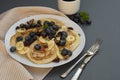 Freshmade, homemade pancakes with blueberry, dried fruits and honey. Breakfast with coffee and pancakes. Deliciious