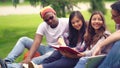 Freshmen reading book sitting outdoors. Royalty Free Stock Photo