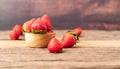 Freshness ripe strawberries are in a wooden bowl placed on the table