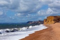 Freshwater Bay beach and waves Dorset view towards sandstone cliffs, West Bay Royalty Free Stock Photo