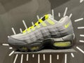 A photo of the 2021 New Nike neon yellow laces on grey shoe