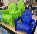 Bright colored plastic lawn chairs for kids on shelf