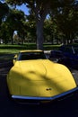 Bright Yellow 1972 Classic Chevy Corvette Parked next to a lush green Park, Fresno, USA