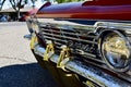 Closeup of silver engraved back end of a Classic 1966 Orange Sparkled Chevy IMPALA Car