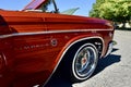 Of silver engraved back end of a Classic 1966 Orange Sparkled Chevy IMPALA Car