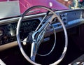 Closeup of steering Wheel Wine Colored Classic C10 Chevy Pickup Truck and white top with hood up Royalty Free Stock Photo