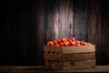 Fressh Red tomatoes box on wooden table Royalty Free Stock Photo