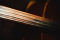 Fretboard of old shabby cello on a black backgrounds Royalty Free Stock Photo